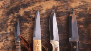 Different types of outdoor knives, from carbon to stainless steel, compared side by side.