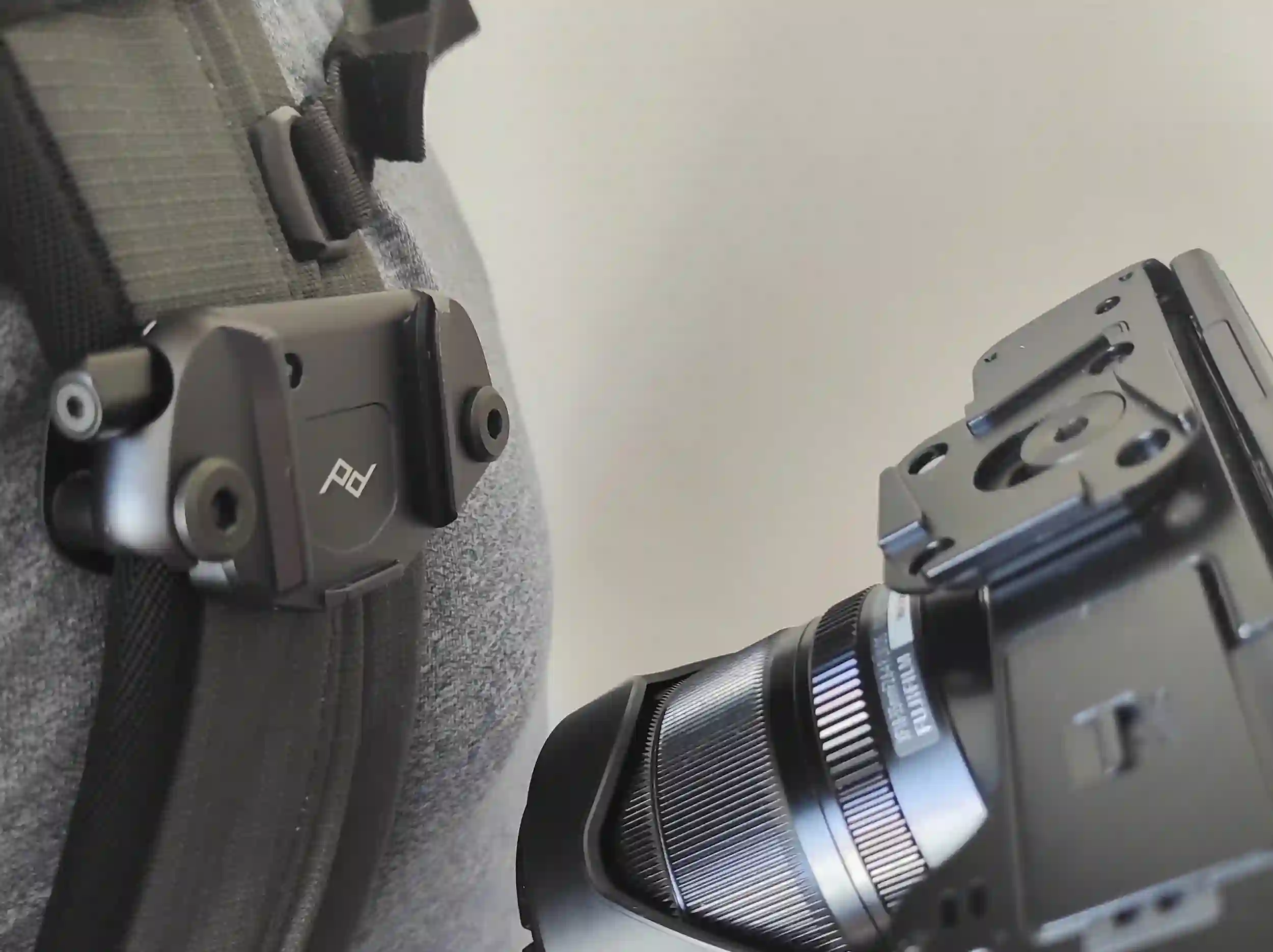 A DSLR camera about to be secured to the Peak Design Camera Clip V3.