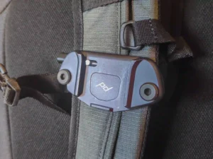The Peak Design Camera Clip V3 attached to a backpack shoulder strap.