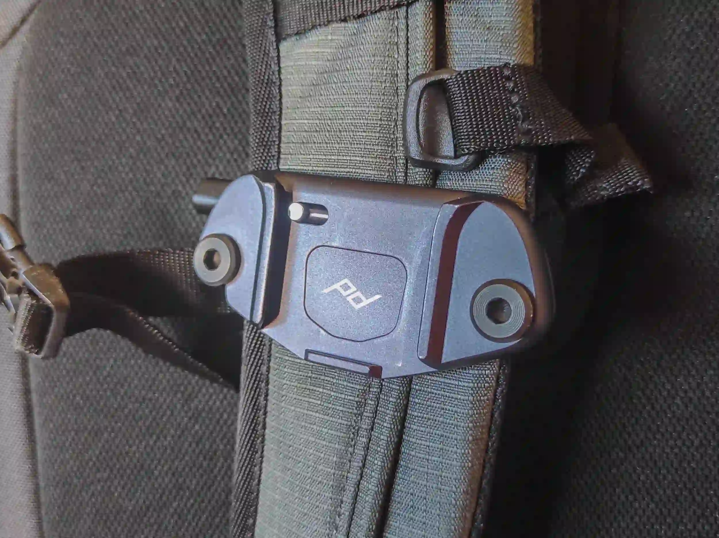 The Peak Design Capture Camera Clip V3 attached to a backpack shoulder strap.