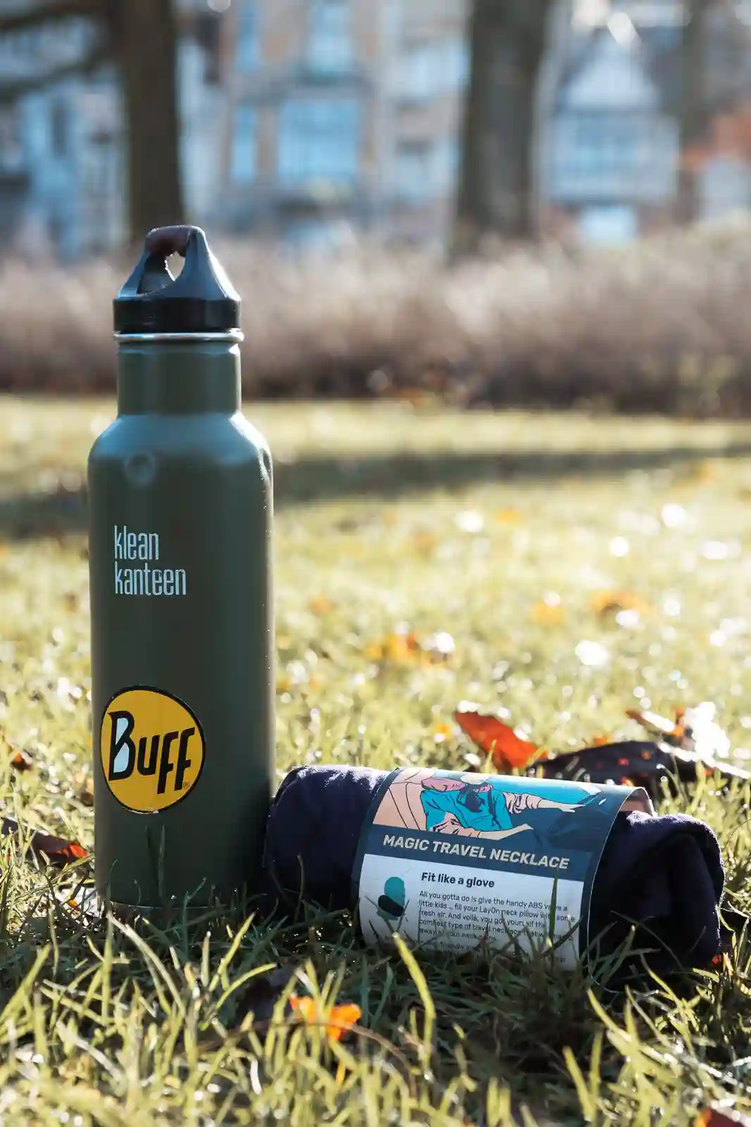 A packed LayOn Magic Neck Pillow next to a Klean Kanteen water bottle to showcase the size.