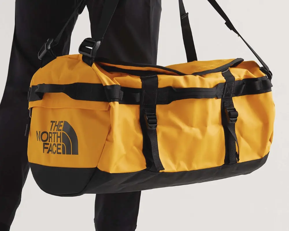A product shot of The North Face Duffel in yellow and black.