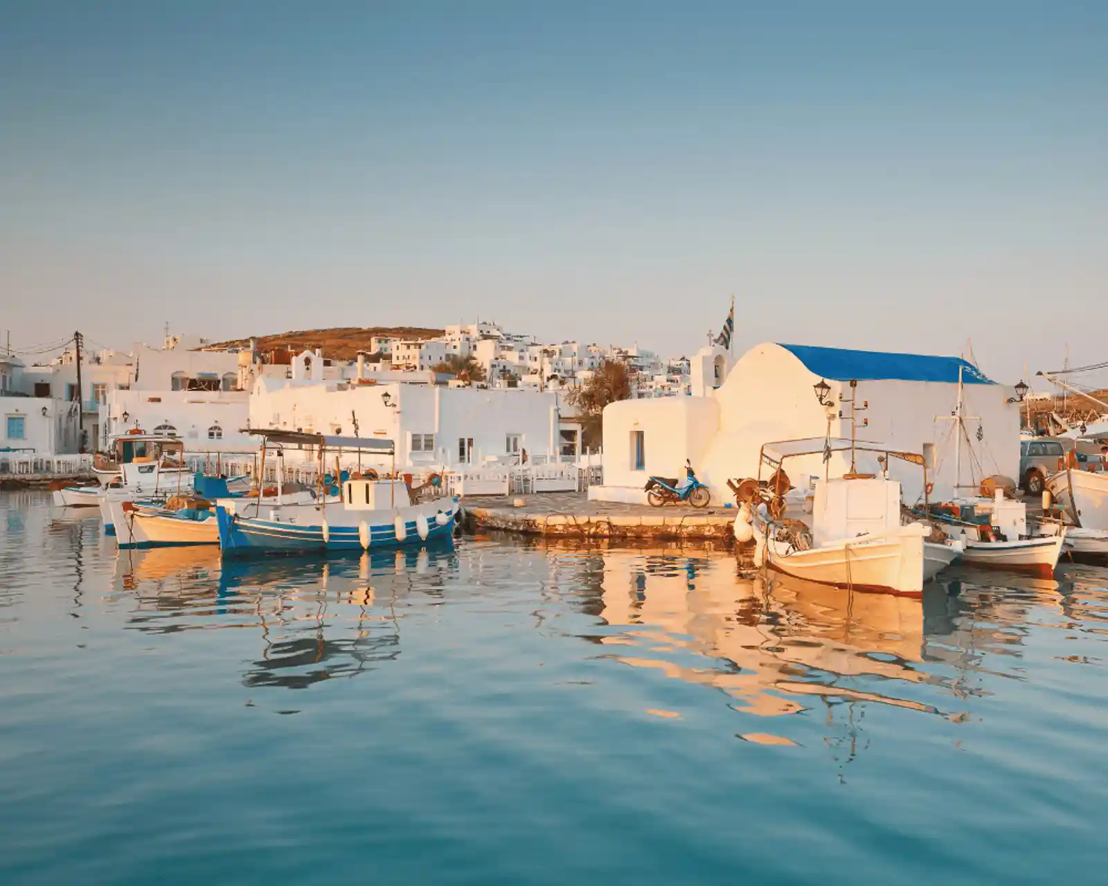 Sunset by the shore in the island of Paros in Greece.