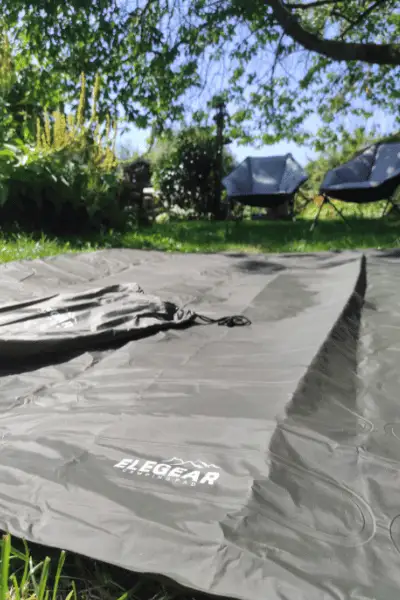Elegear sleeping pad deflated and being used outdoors.