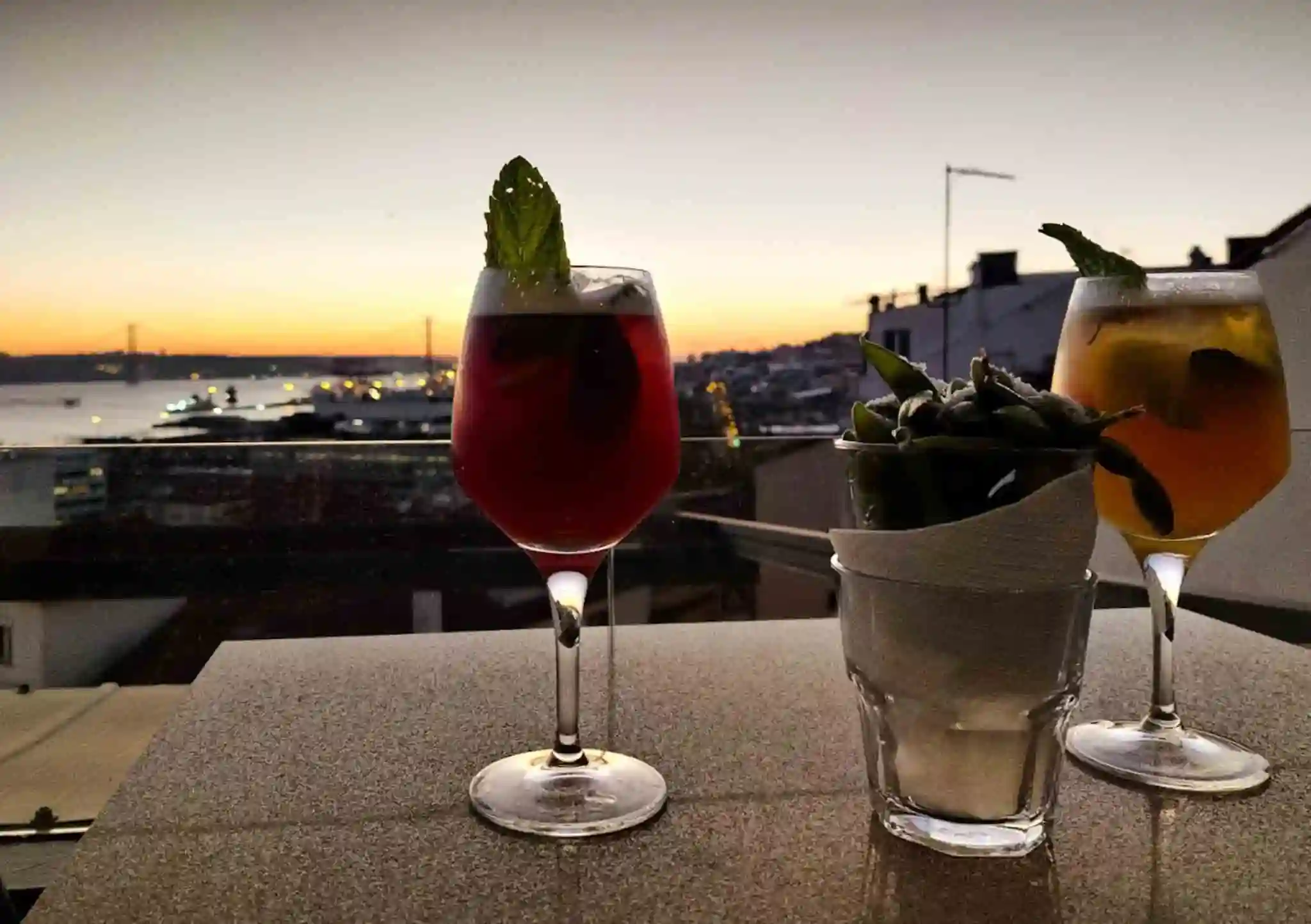 Cocktails at sunset at the Noobai rooftop bar in Lisbon, Portugal.