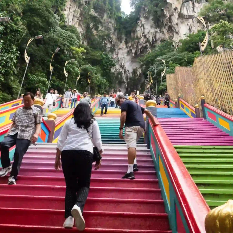 Visitors climbing the colourful stairs leading to the Batu caves in Malaysia.