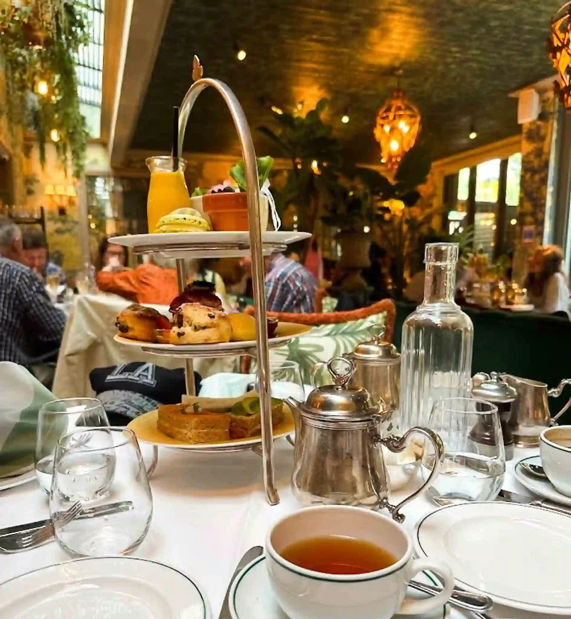 Tea and pastries at the Ivy Chelsea Garden Café in London, UK.