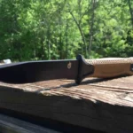 A Gerber Strongarm outdoor knife on a block of wood.