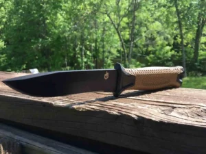 A Gerber Strongarm outdoor knife on a block of wood.