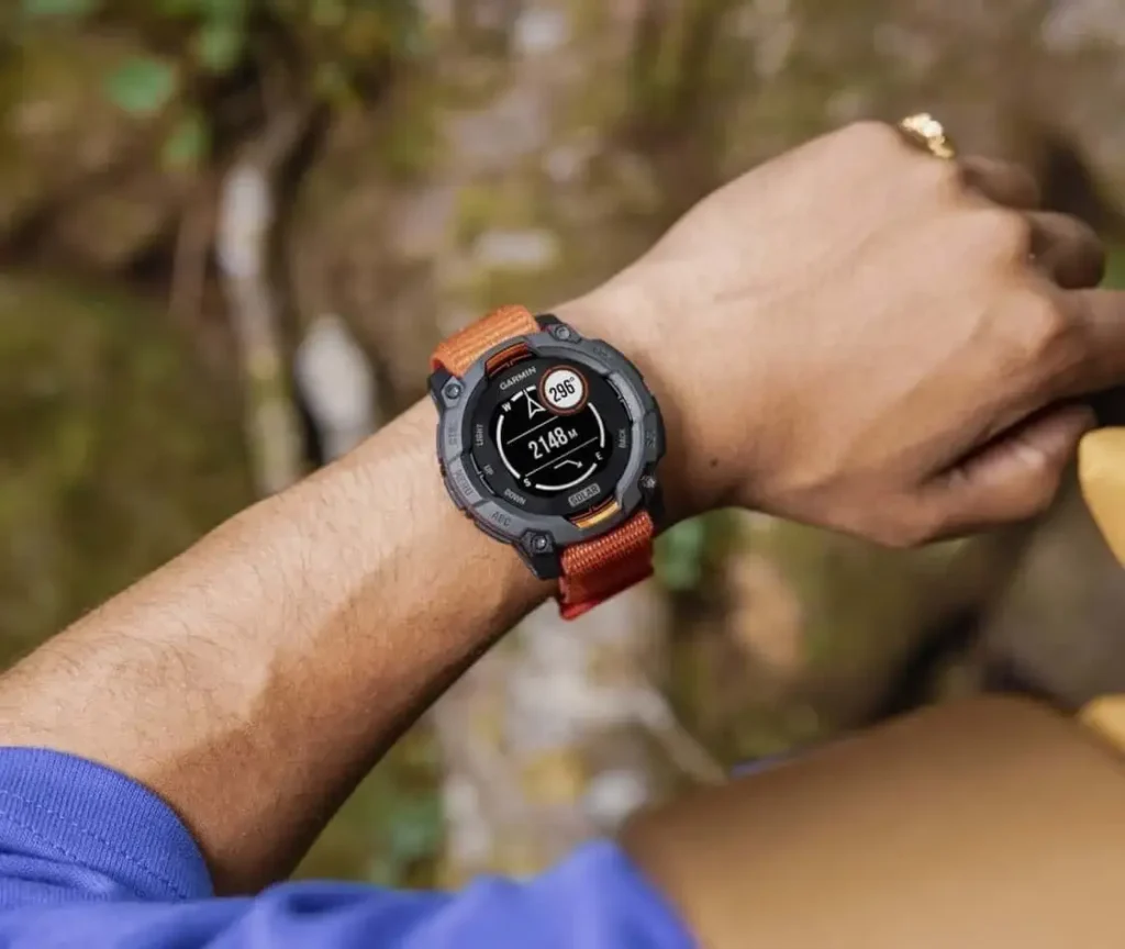 A Garmin Instinct 3 on the wrist.