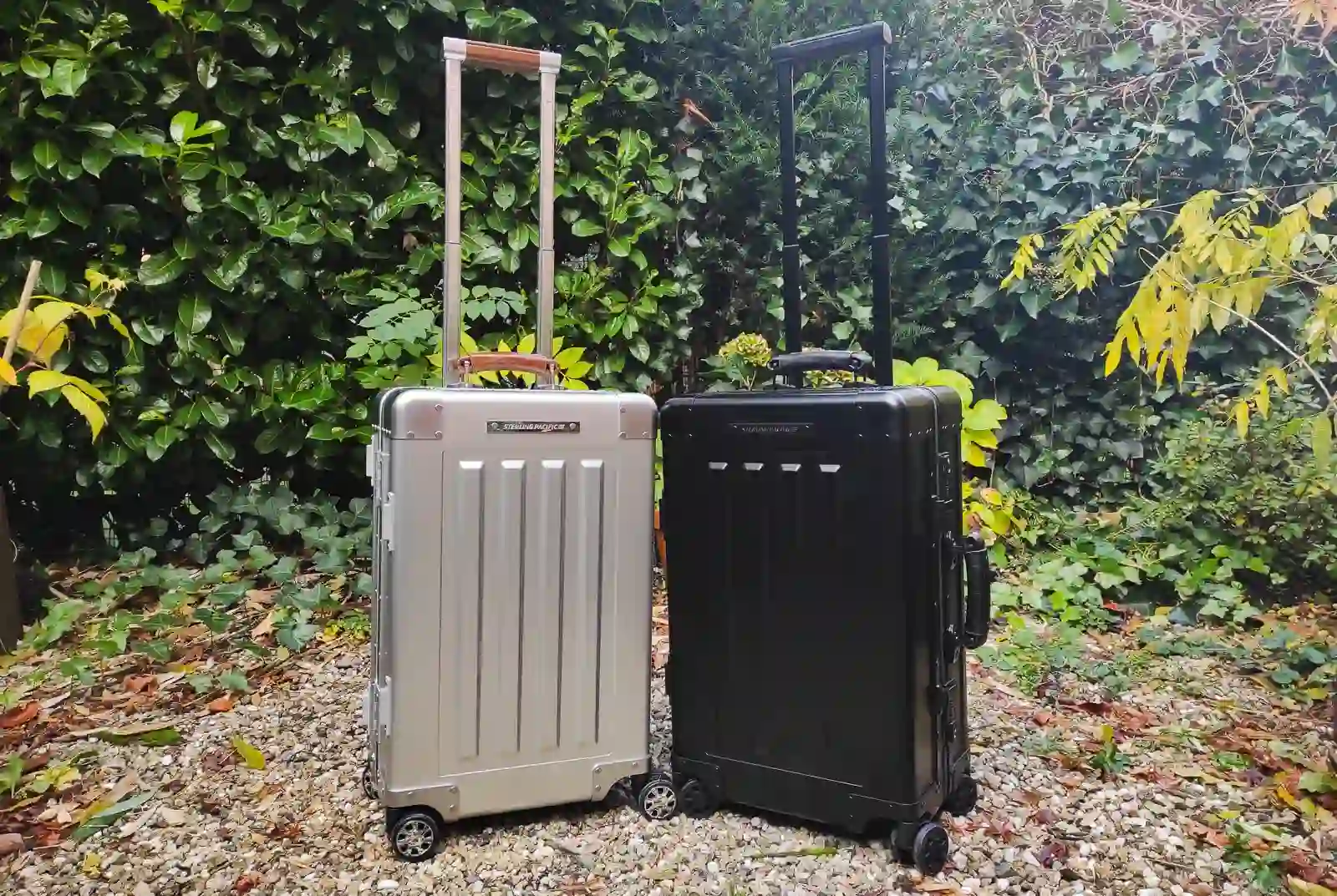 Sterling Pacific 40 litre suitcases, one metal grey and the other black.