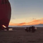 A hot air ballon preparing for take off at sunrise, during our hot-air balloon experience in Marrakech.