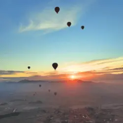 View of hot air ballons and the sun rising over the desert near Marrakech, Morocco