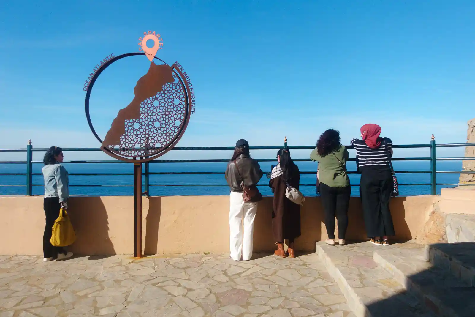 Tourists enjoying the sea views from the Cap Spartel in Tangier, Morocco.