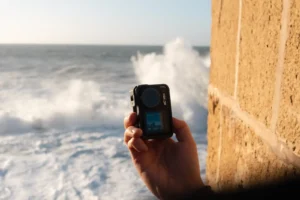 A closeup of a hand holding the DJI Osmo Action 4.